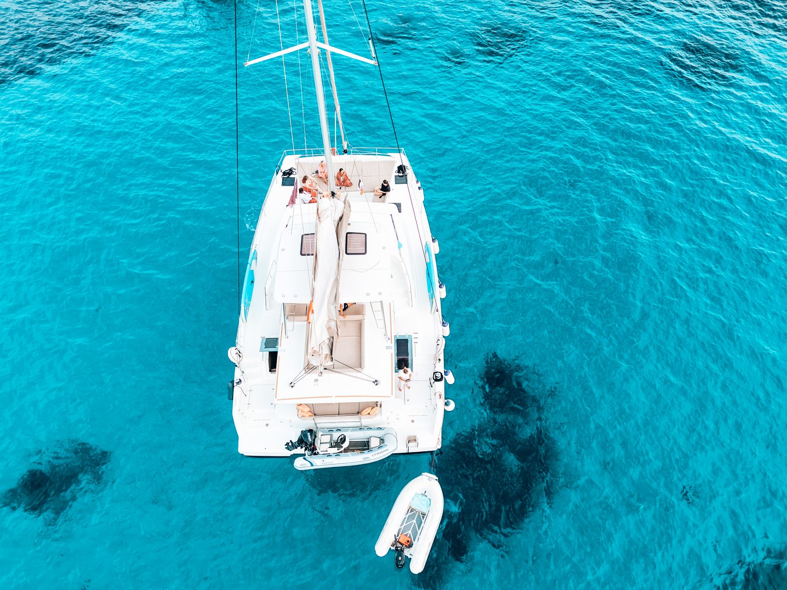 Overhead view of guests relaxing on a catamaran deck